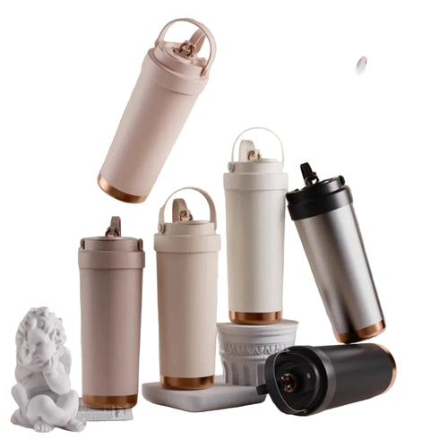 Ceramic‑coated stainless steel travel tumblers in assorted colors on decorative stands